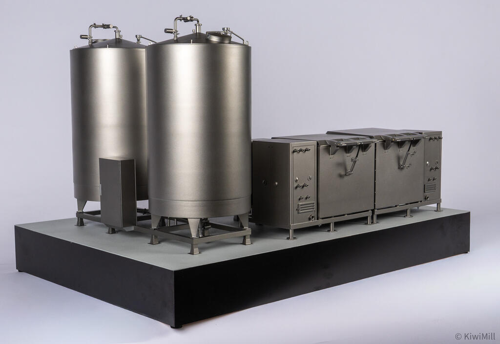 Rear side view of the model with tall water tanks and conical bottoms at left and the cook tank units at right